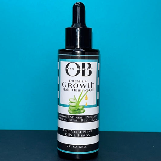 A black 2ml, 60 fl oz glass bottle of herbal hair growth oil. The oil has aloe vera, oils and herbs.