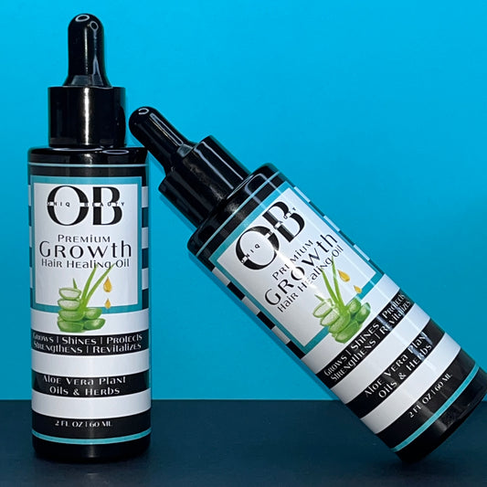 Two black 2ml, 60 fl oz glass bottles of herbal hair growth oil. ONIQ Beauty Premium Growth Hair Healing Oil with Aloe Vera, Oils and Herbs. Vegan, Alcohol-free, Chemical-Free, Not tested on animals. The oil has Aloe Vera, oils and herbs.