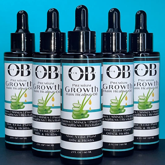 Five black 2ml, 60 fl oz glass bottles of herbal hair growth oil. ONIQ Beauty Premium Growth Hair Healing Oil with Aloe Vera, Oils and Herbs. Vegan, Alcohol-free, Chemical-Free, Not tested on animals. The oil has Aloe Vera, oils and herbs.